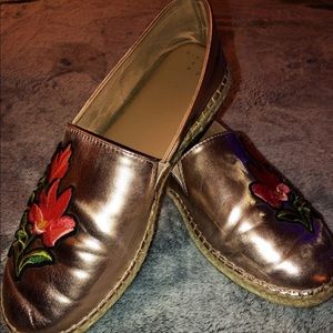 Rose gold slip ons with flower appliqué